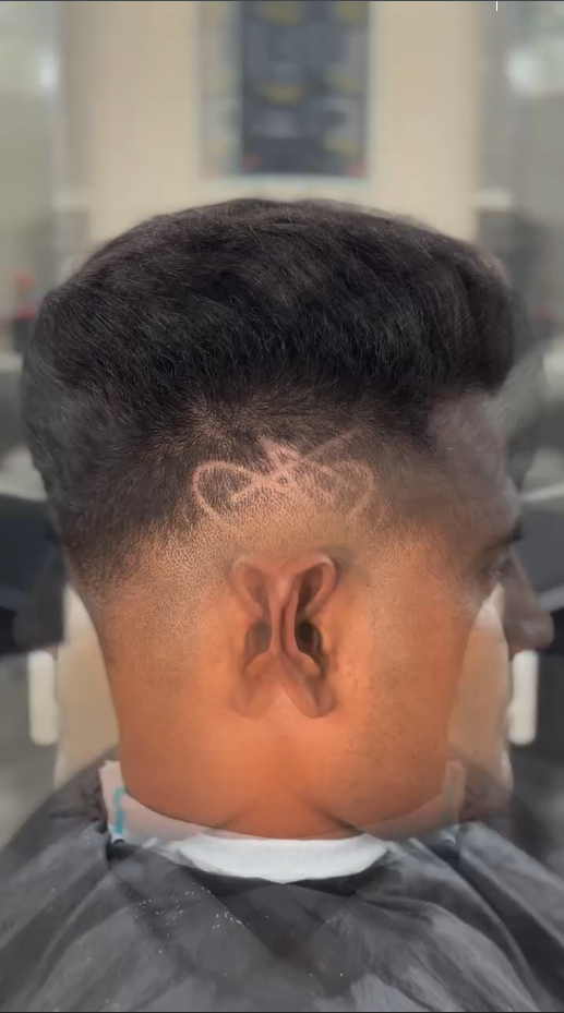 Motorbike hair design with mid to high skin fade – sharp razor artwork above ear – CXI Salon Palwal, modern men haircut Haryana. Best hair Salon in palwal